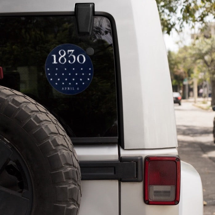 Window decal with LDS 1830 church restoration sticker on a car window
