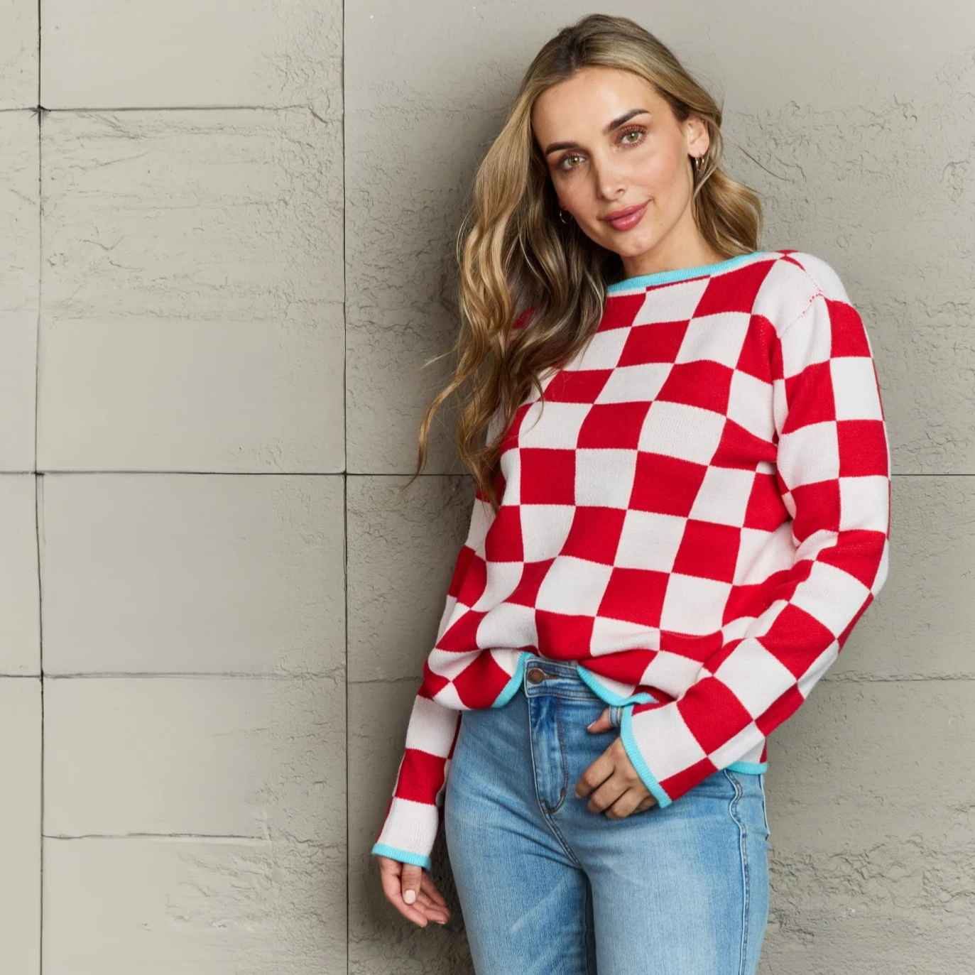 girl wearing red checkered sweater with light blue piping detail