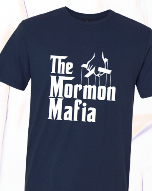 A navy blue short-sleeve t-shirt with a white graphic print reading 'The Mormon Mafia' from LDS retail shop Nauvoo Supply Co. 