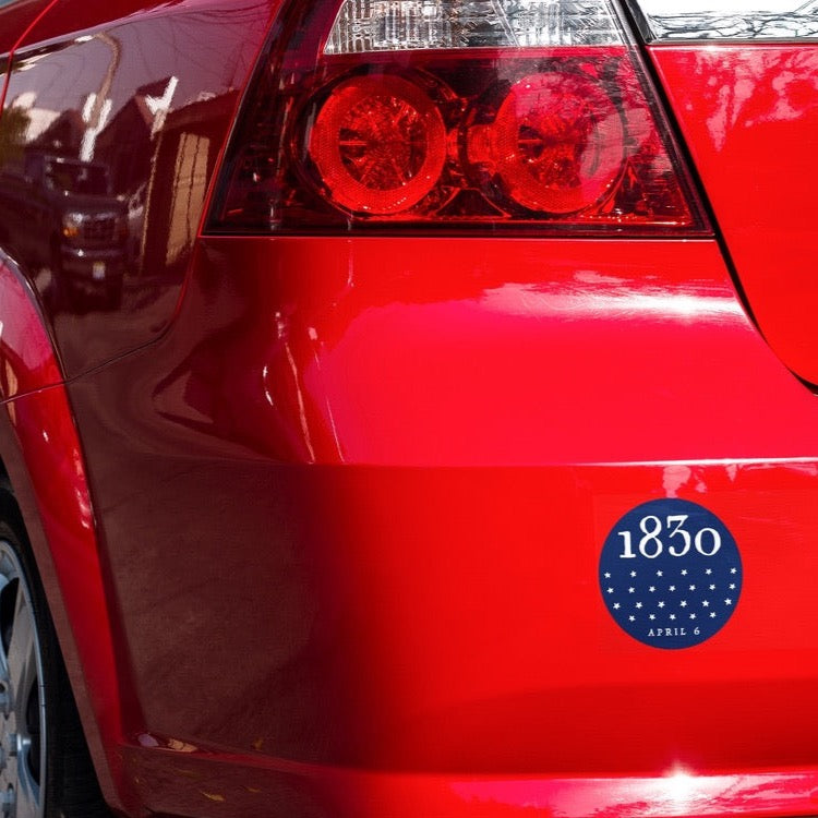 1830 LDS Church restoration bumper sticker on a red car